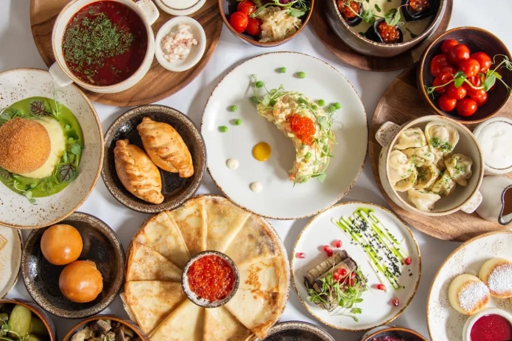 ZIMA feast spread - borscht, pelmeni, caviar blinis, Olivier and syrniki